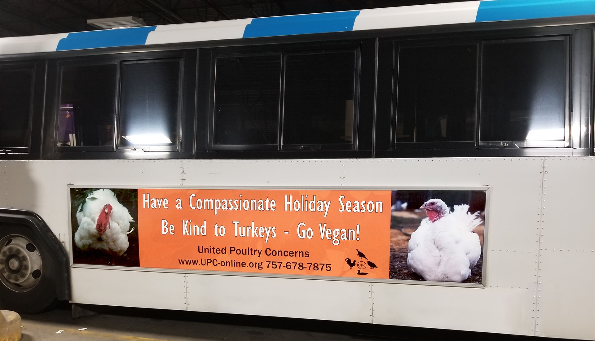 Have a compassionate holiday sign on a bus