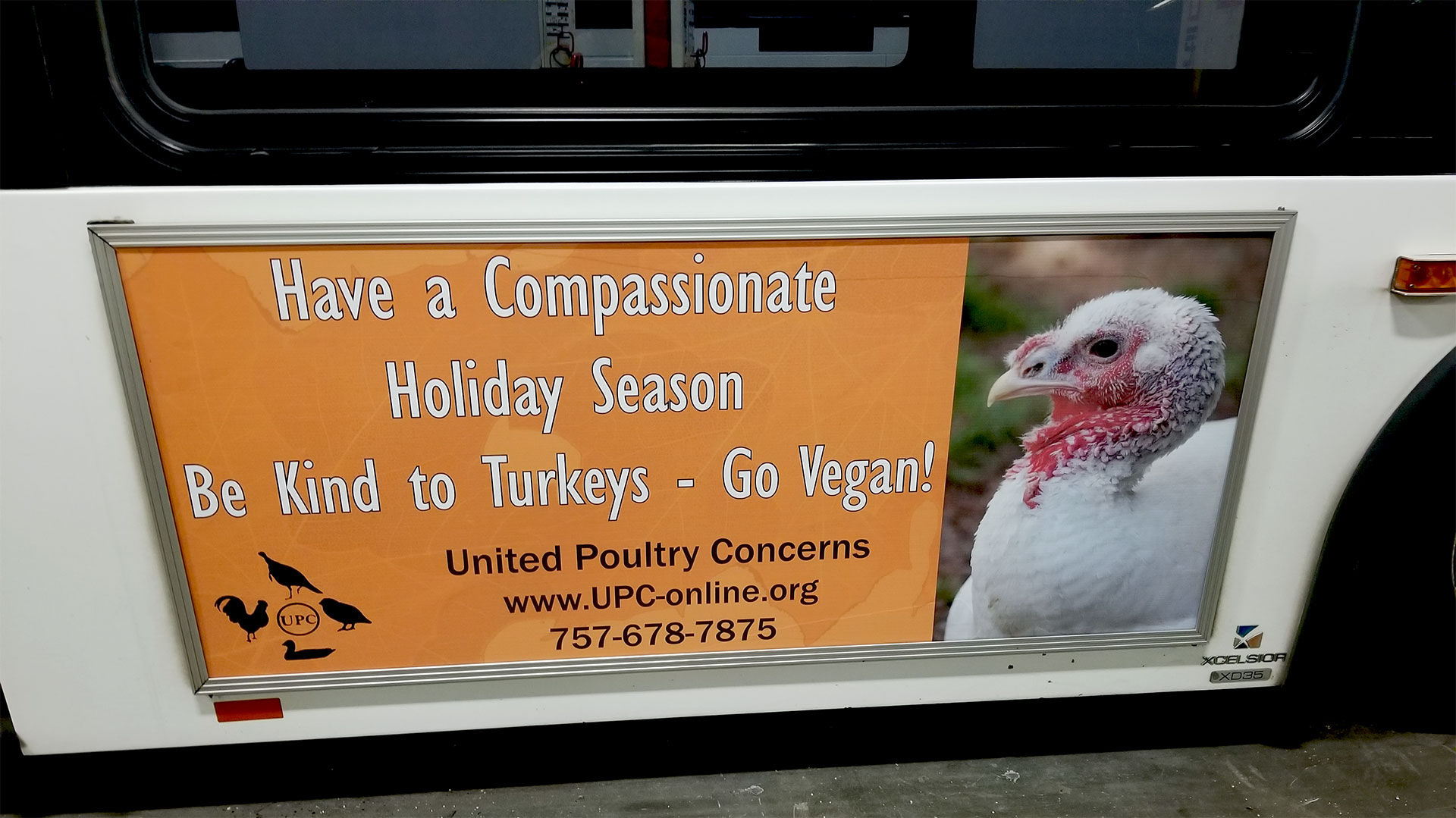 Have a compassionate holiday sign on a bus
