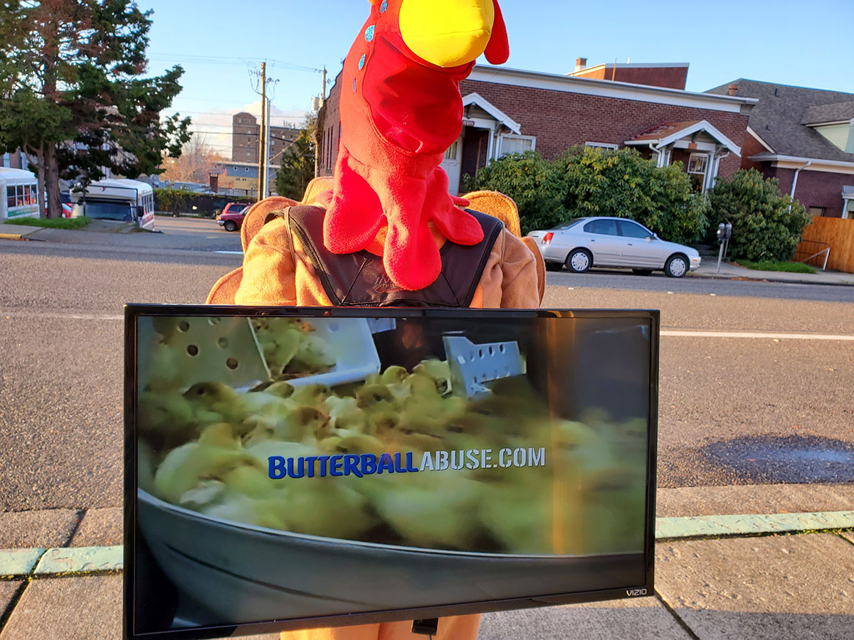 Protester holding video display highlighting Butterball abuse