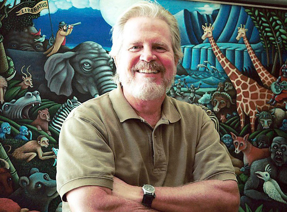 Tom Regan standing in front of animal mural