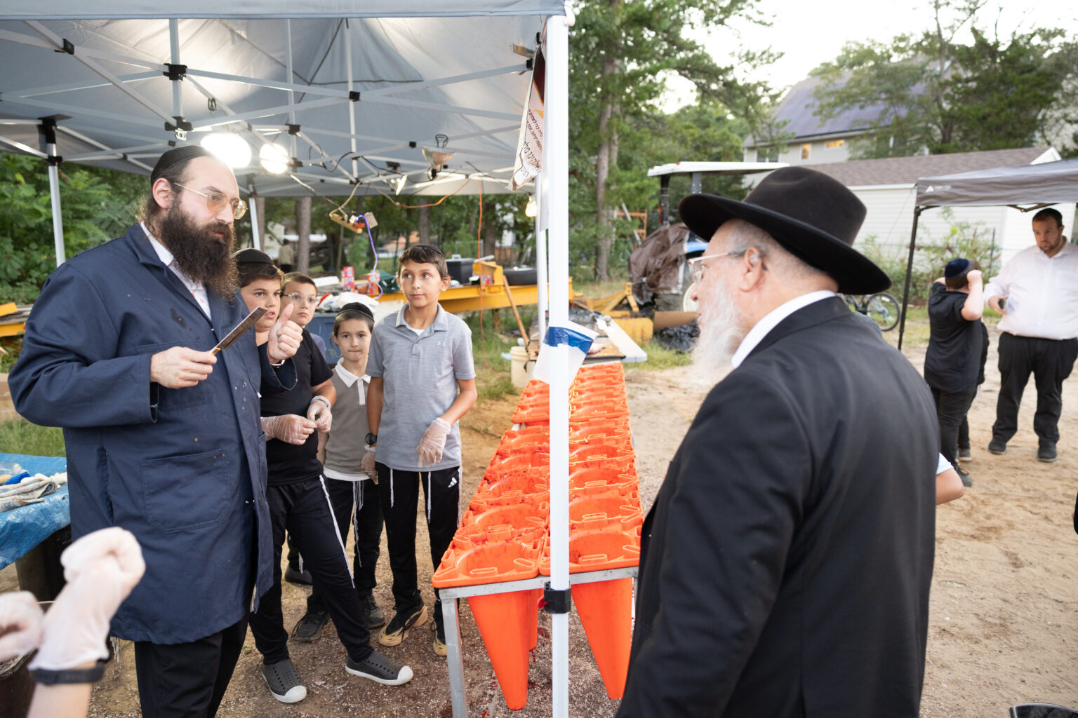 Older Hasidic man wearing a traditional black suit and hat.